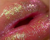 Close-up of pink lips covered in glitter.
