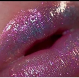 Here are some appropriate alt tags for the image:

*   Close-up of lips with iridescent pink glitter gloss
*   Shiny pink and iridescent glitter on full lips
*   Lips with pink glitter gloss
*   Iridescent and pink shimmering lip makeup
